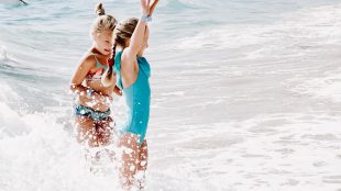 Girls playing at the shore