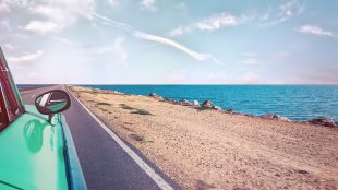 Car driving by the coast